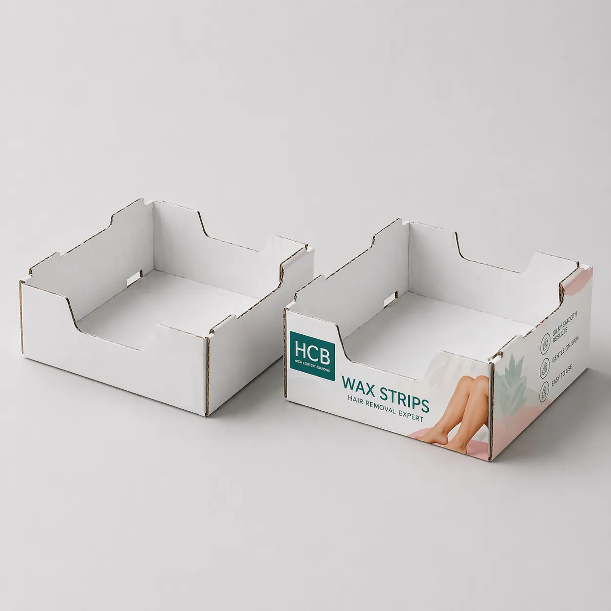 Cardboard shelf ready display trays, one blank white and one printed with pink floral patterns. class=